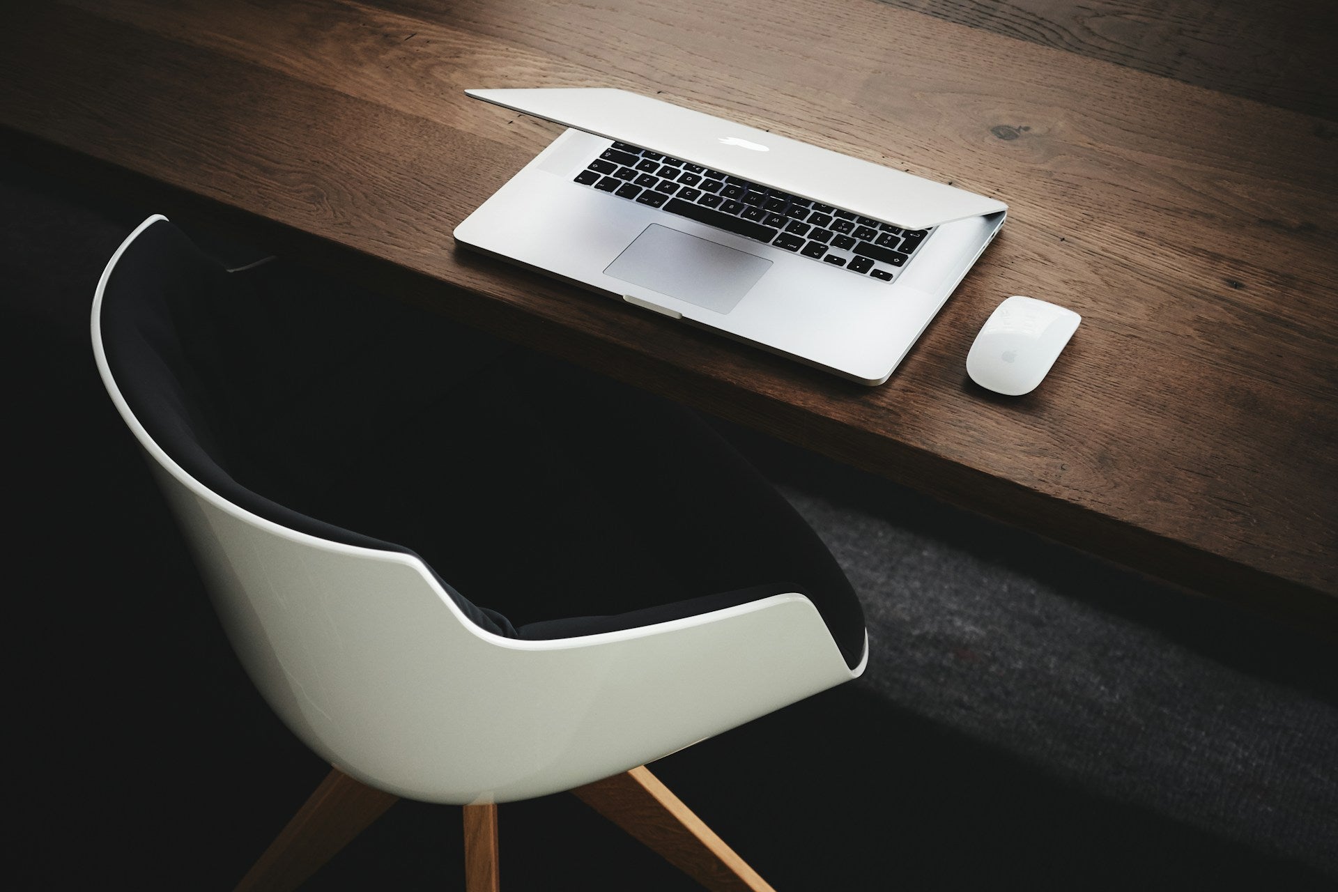 A desk with a laptop and a chair