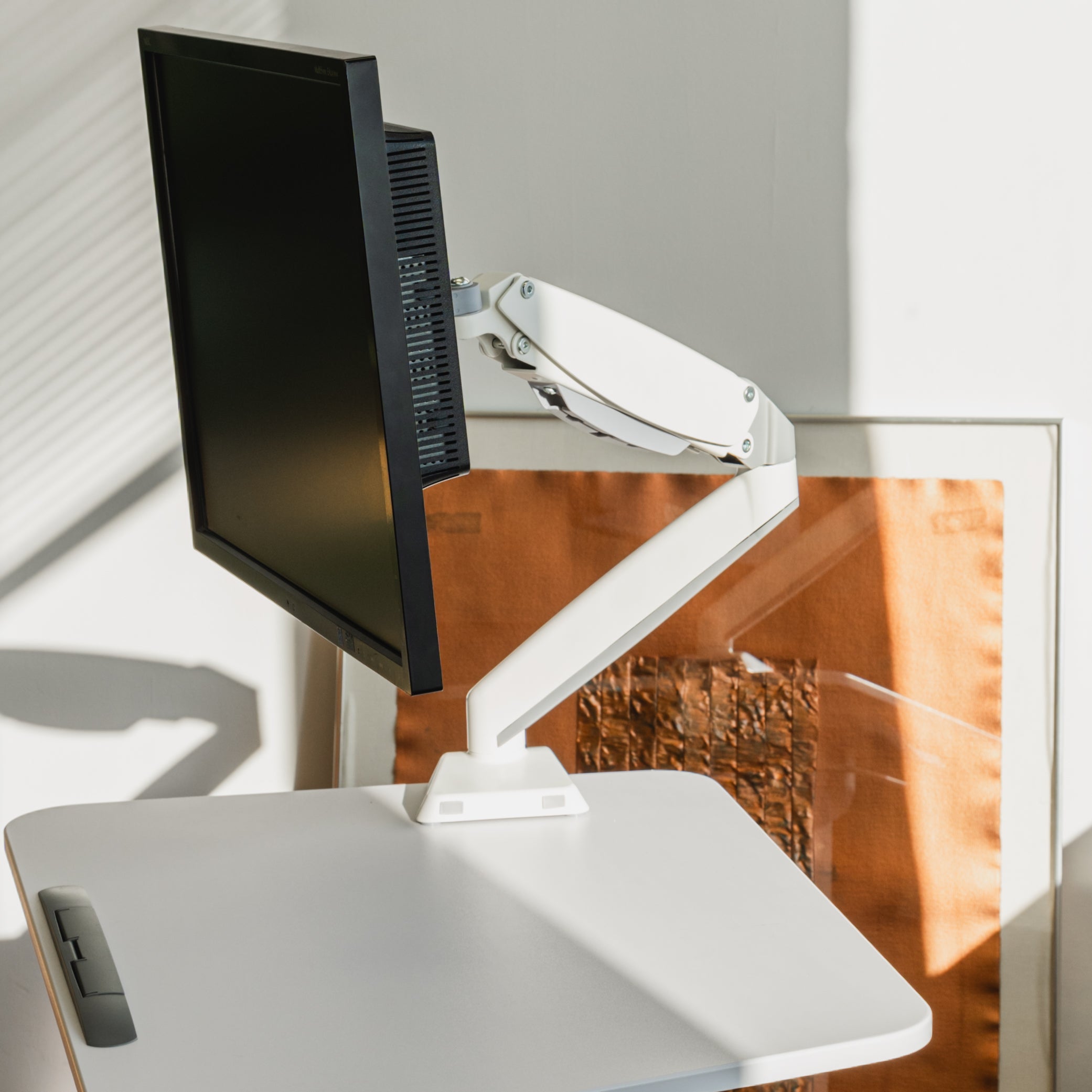 Monitor on a white stand in a home office setting