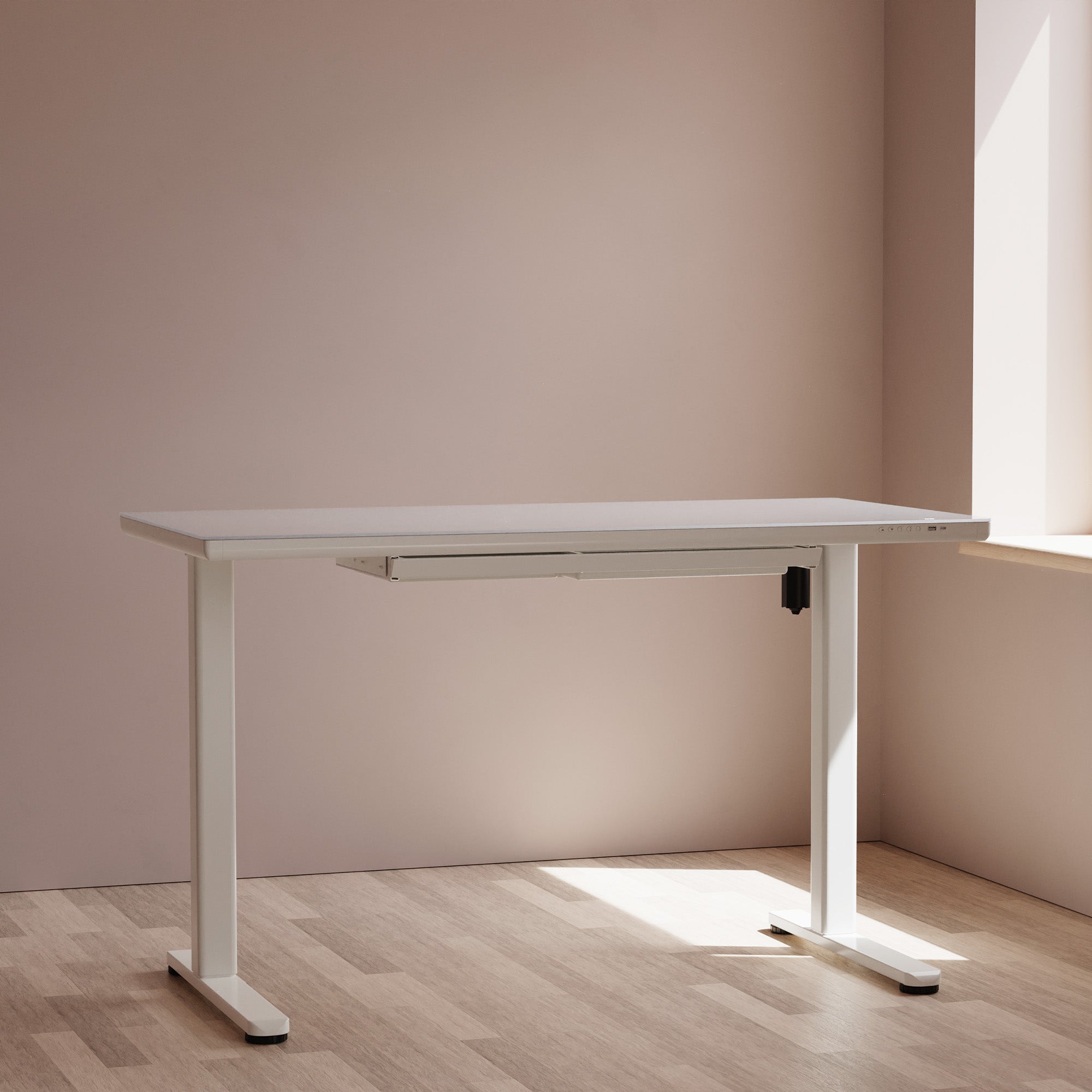 LiftSync Clear ultra glass standing desk
with white frame in a room