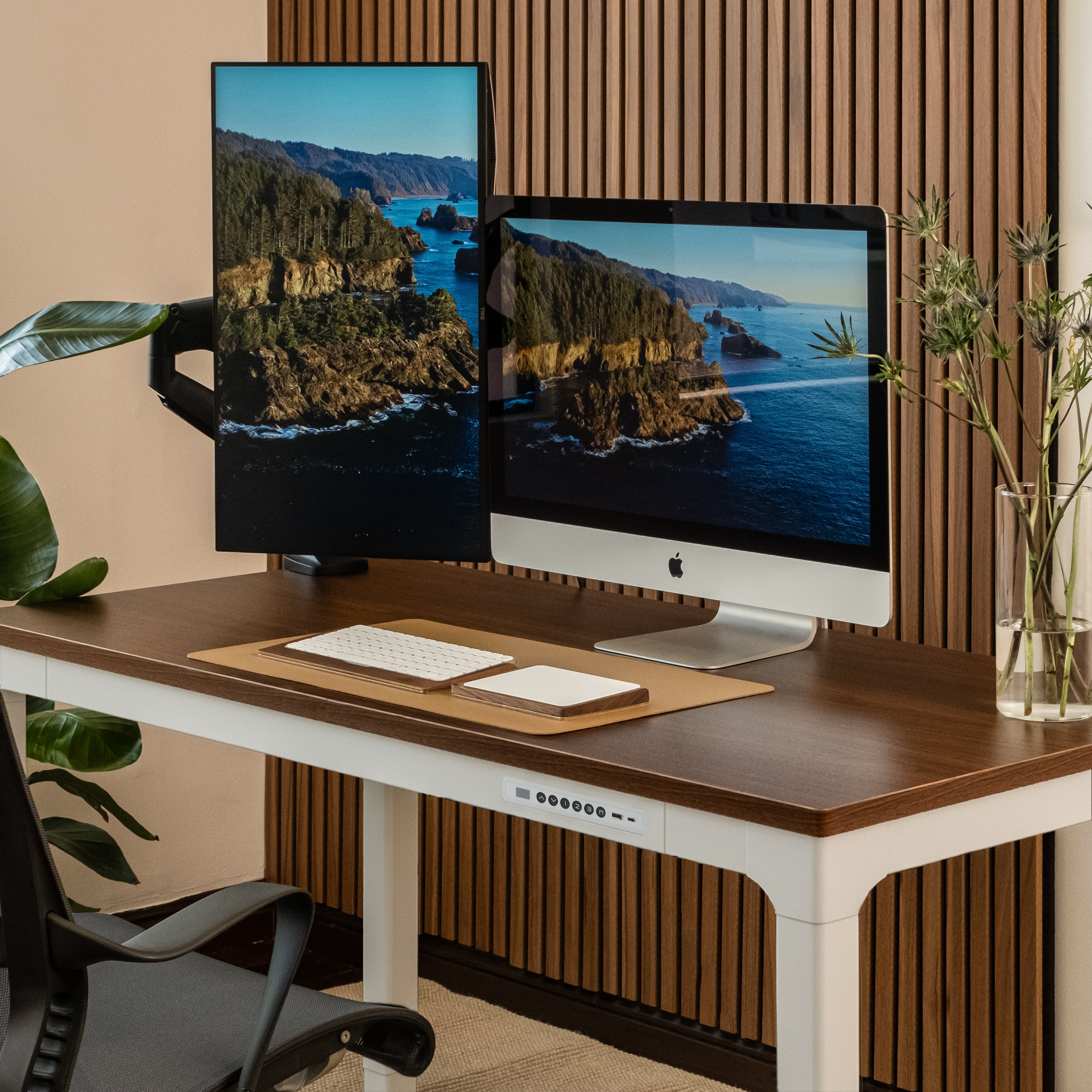 Modern office setup with dual monitors on a wooden desk.