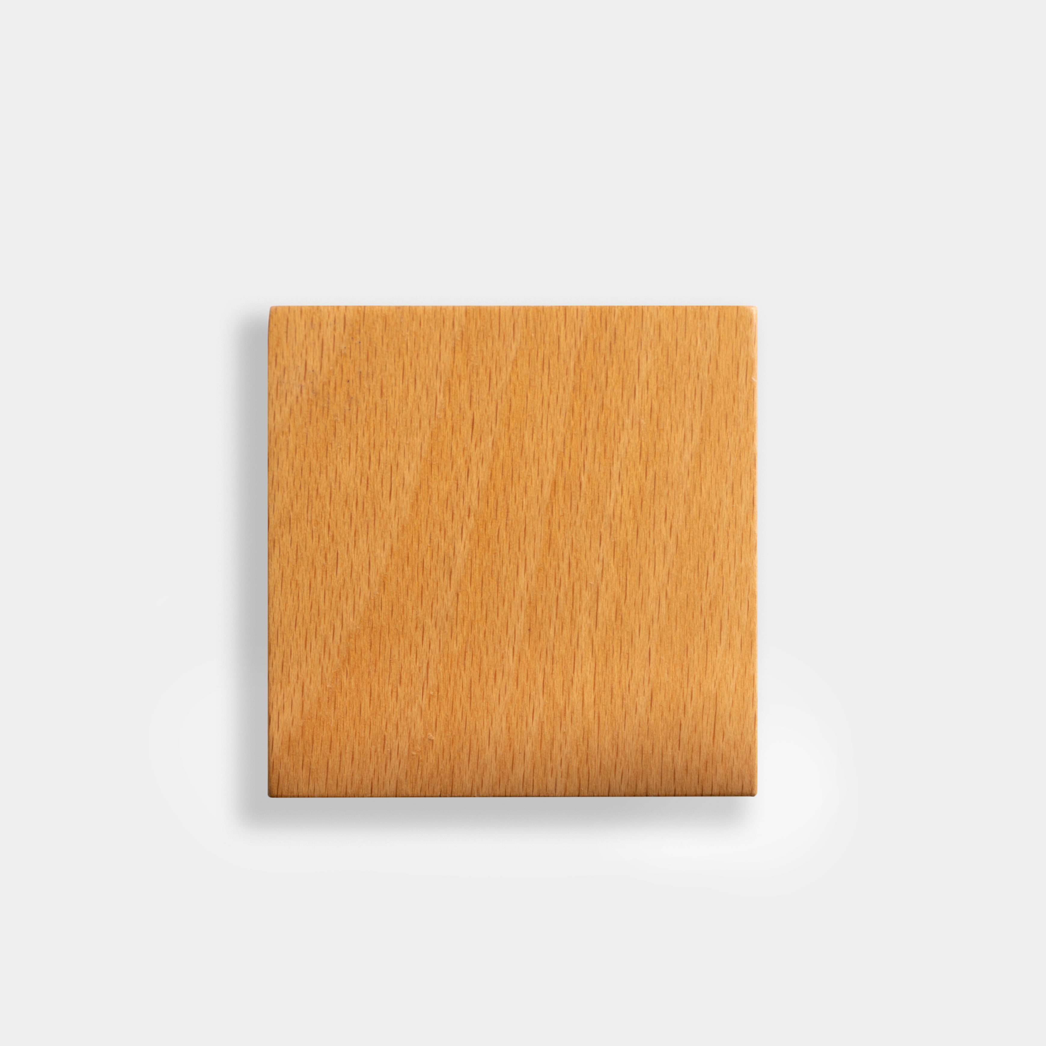 Square wooden block on a light gray background