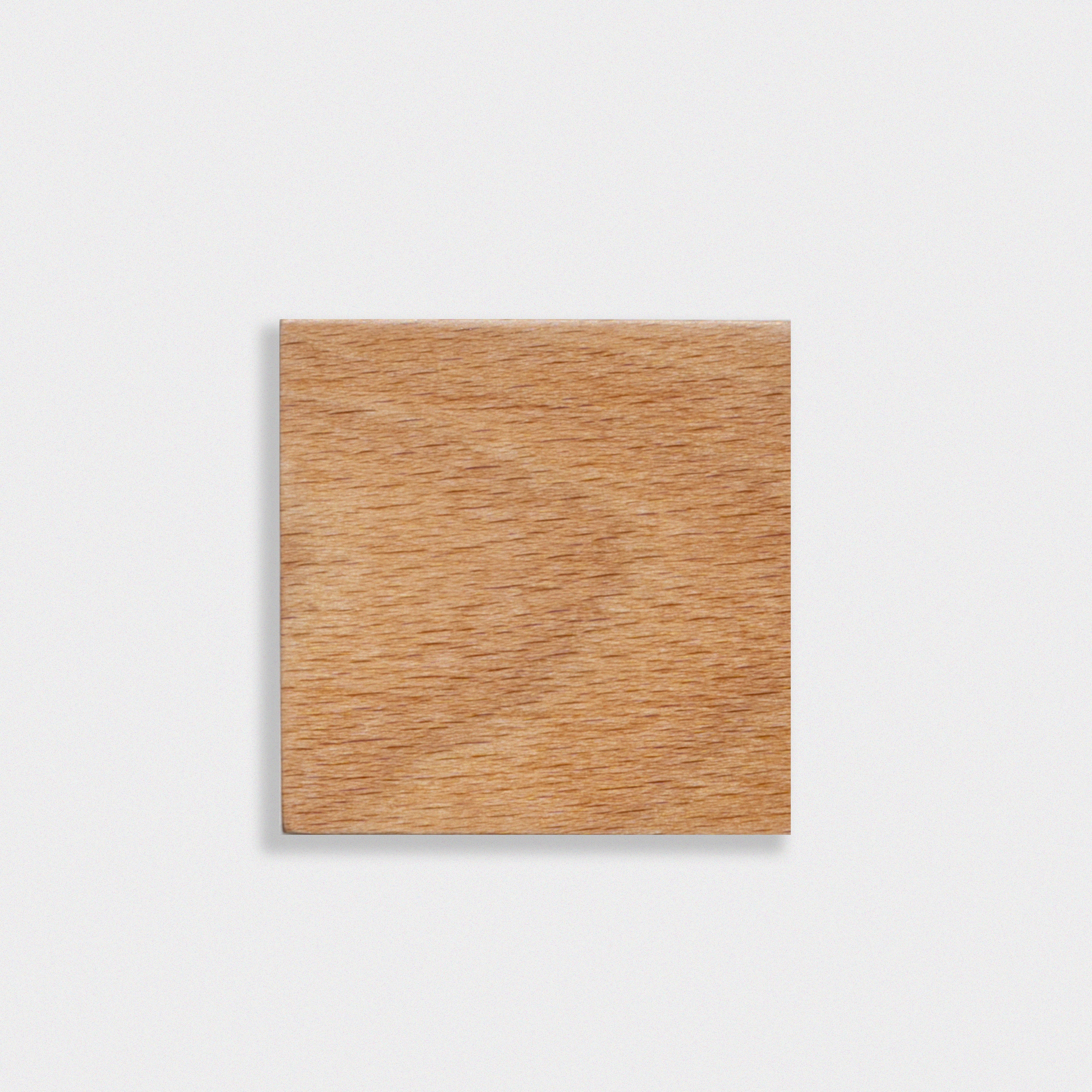 Square wooden block on a light gray background