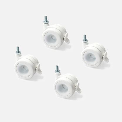 Four white caster wheels on a light gray background