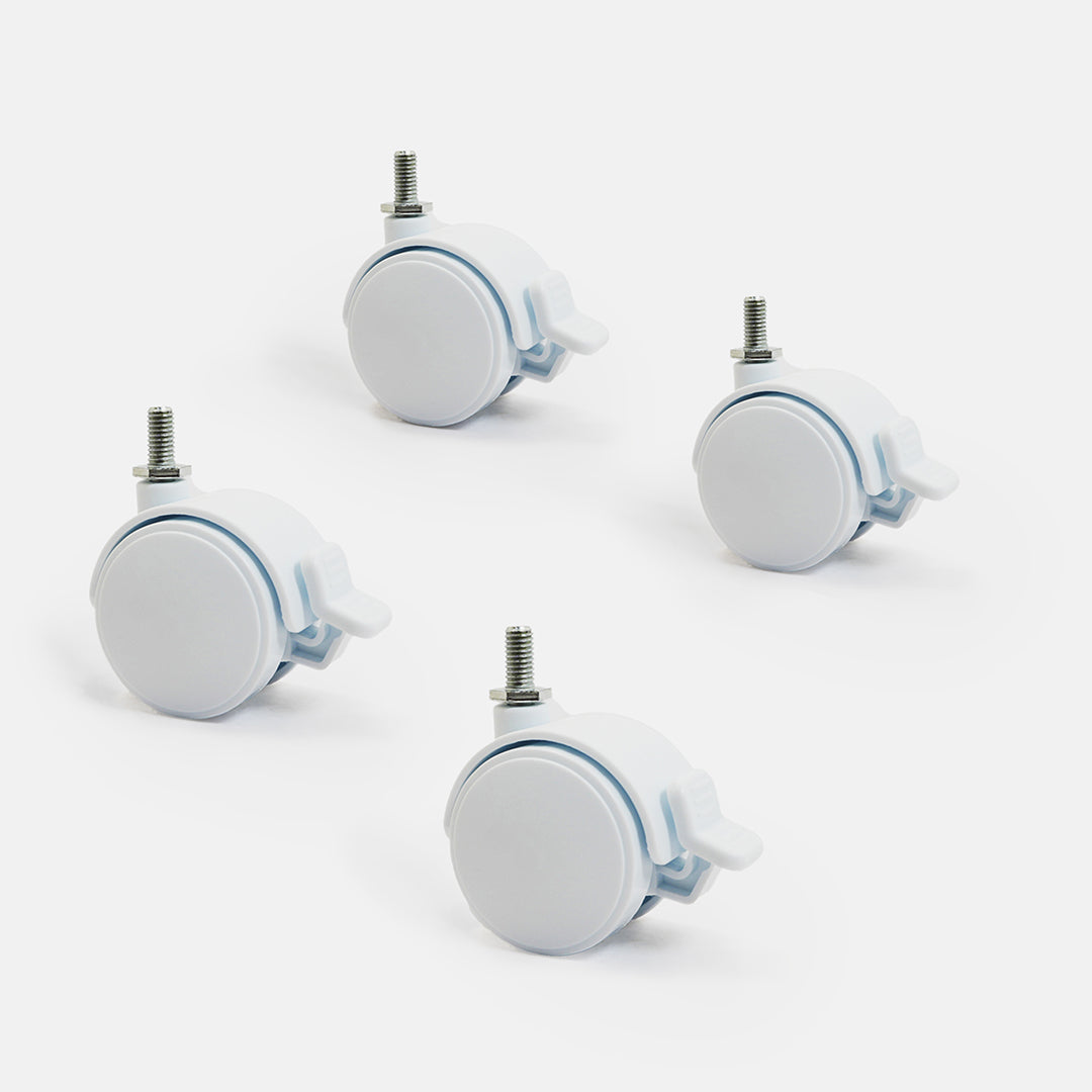 Four white caster wheels with metal axles on a light gray background