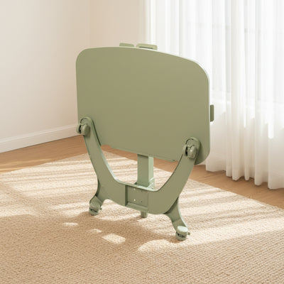 Green adjustable mobile desk on a carpeted floor with a light-colored wall and curtain in the background