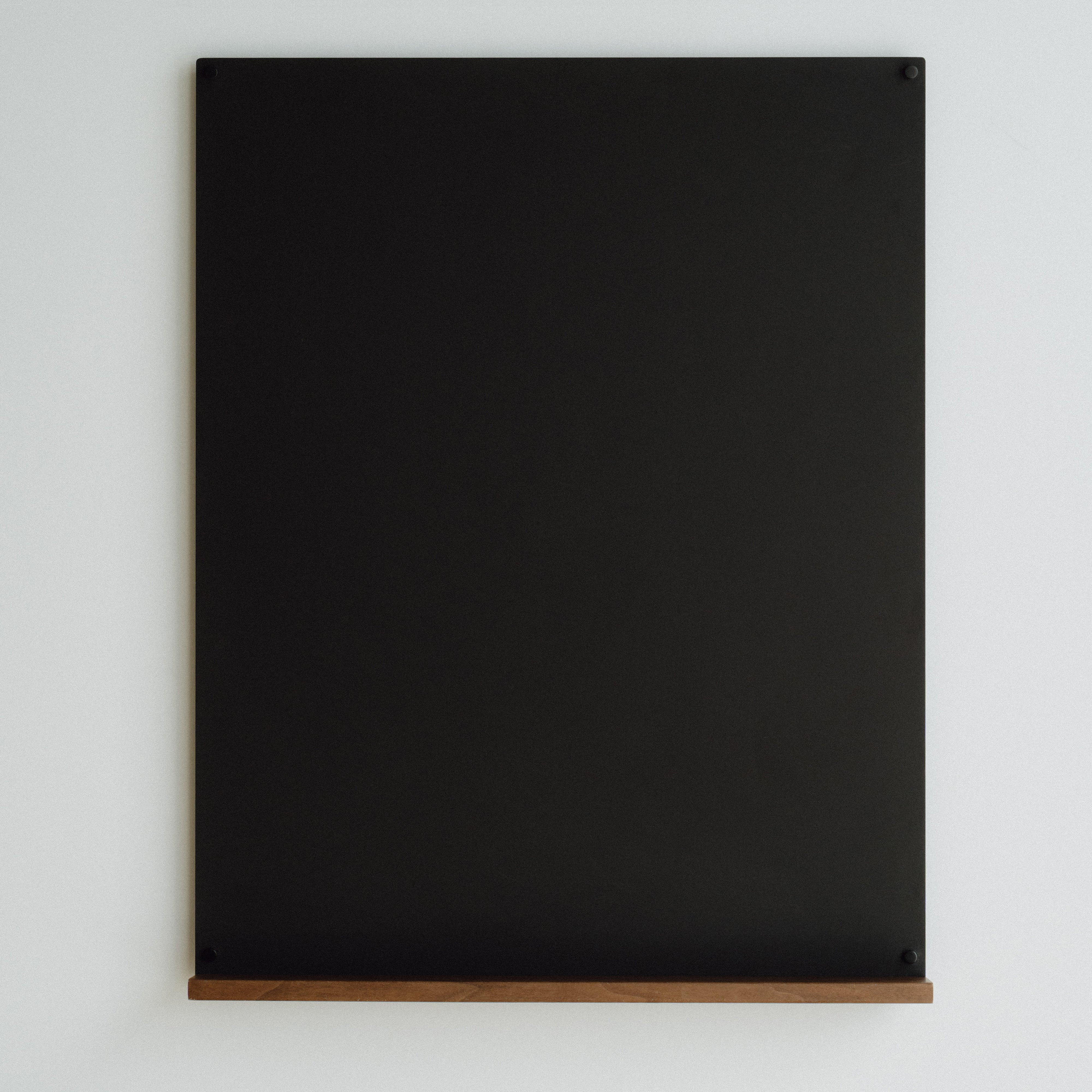 Black magnetic board on a white background