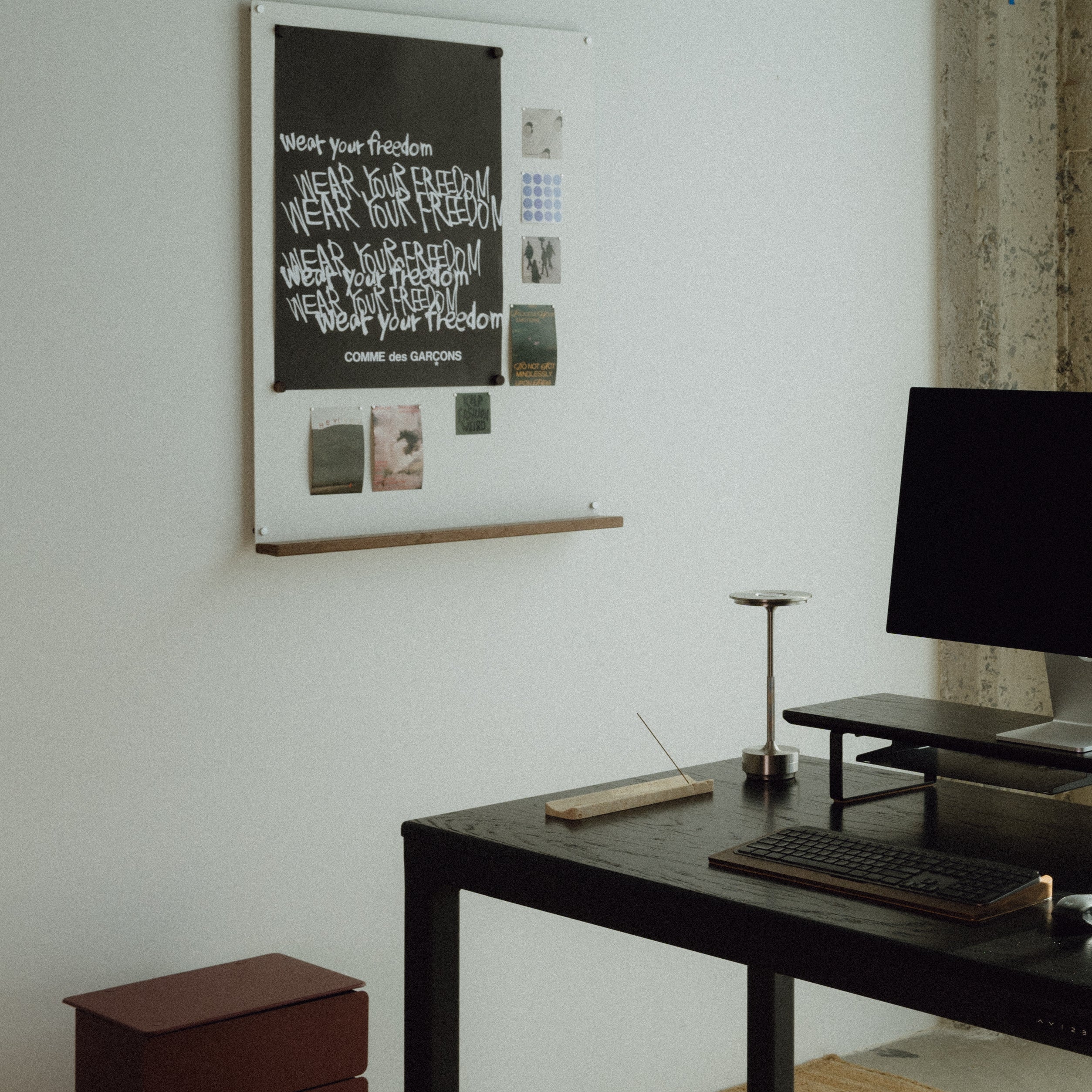 Modern office setup with a four leg standing desk, computer monitor, and white magnetic board