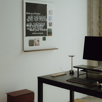 Modern office setup with a four leg standing desk, computer monitor, and white magnetic board