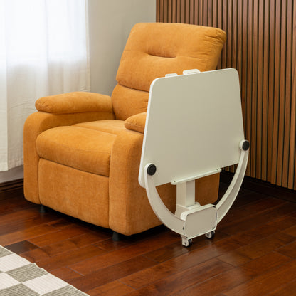 Orange recliner chair with a white adjustable mobile desk in a room with wooden flooring and curtains.