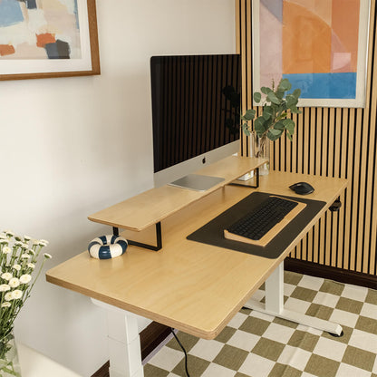 Modern home office with a wooden desk, computer setup, and decorative elements.