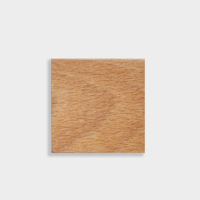 Square wooden block on a light gray background